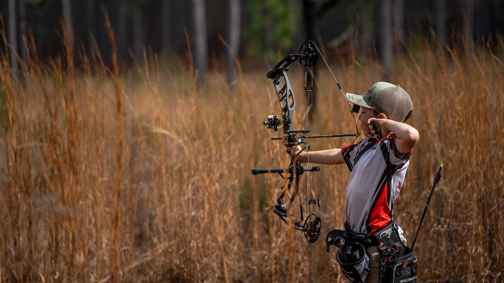 A new archer shooting a compound bow outdoors