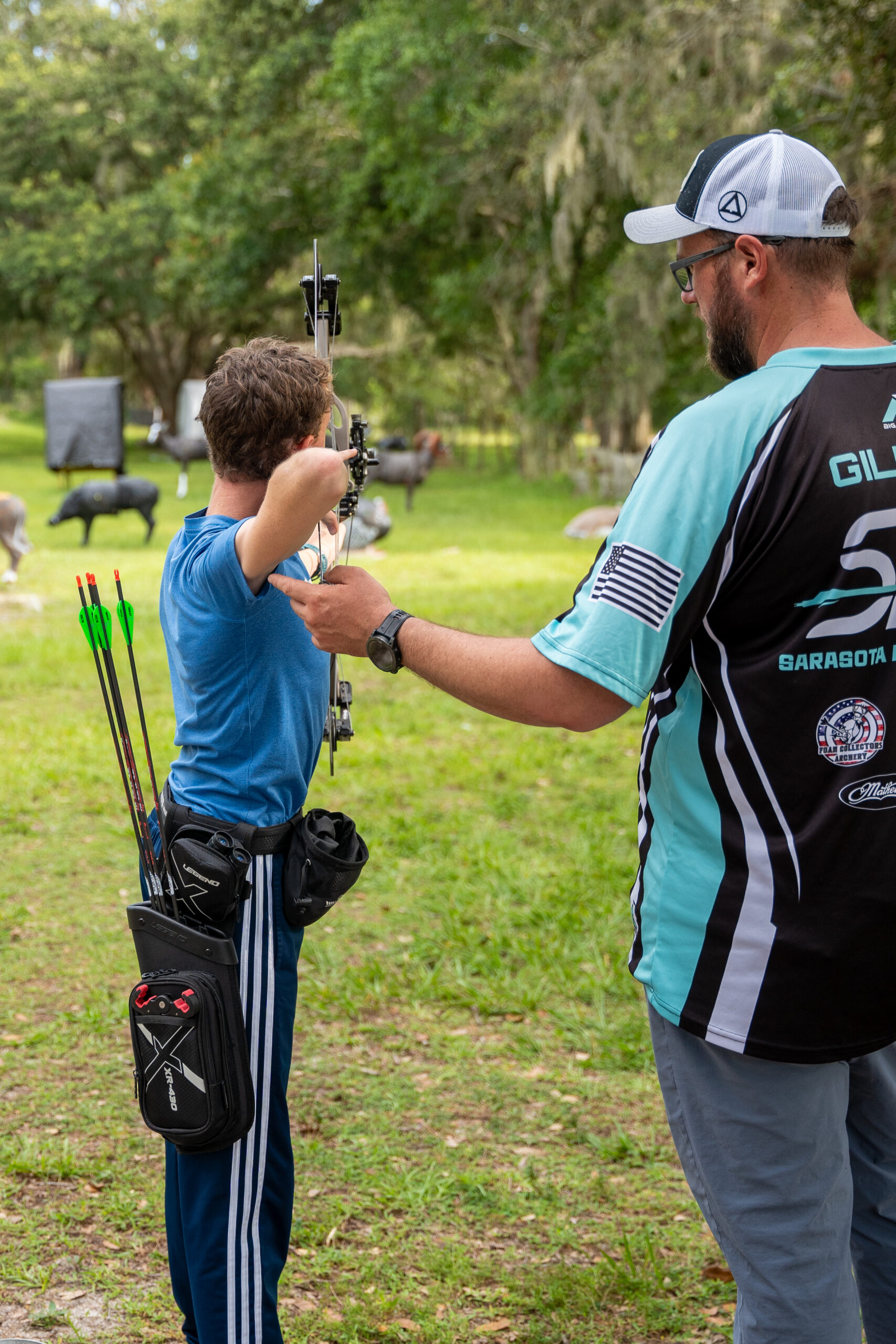 Coach Rob Gilbert coaching a youth archer one-on-one at Archery Sarasota in Sarasota, FL