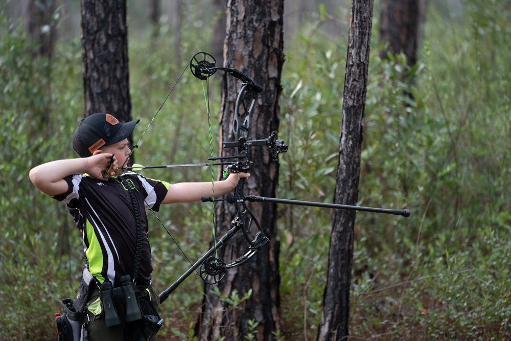 Youth archer at full draw with perfect form at Archery Sarasota in Sarasota, FL